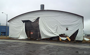 Exterior photo of Hangar 13, wrapped in vinyl tarps, at Canadian Forces Base Borden, Ontario