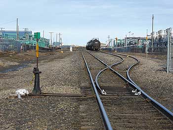 A train sits on tracks at an industrial depot